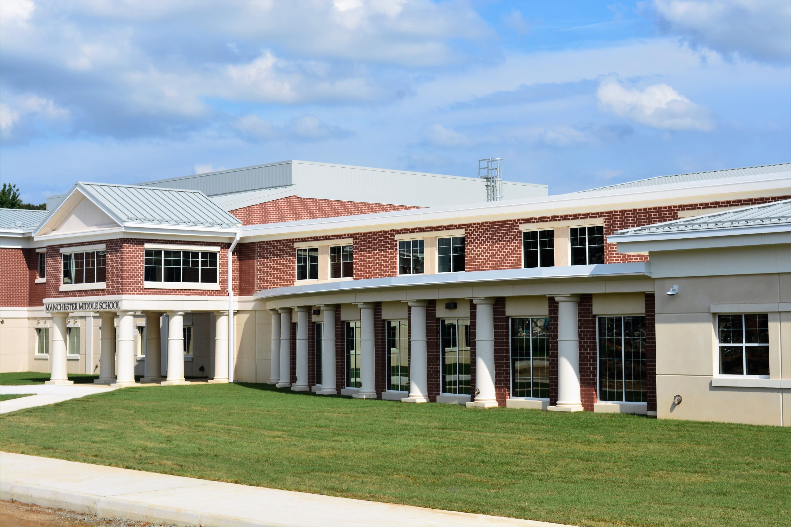 An exterior view of a public school constructed using precast concrete wall panels.