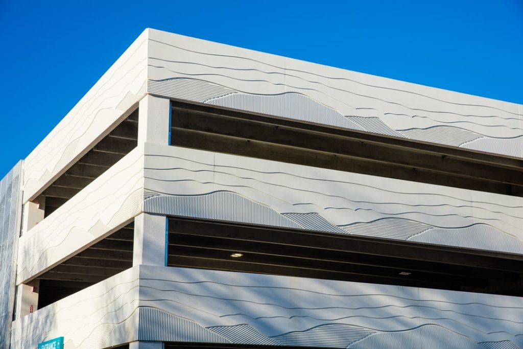 A parking garage that features exterior precast concrete walls with form-lined patterns to resemble nearby mountains.